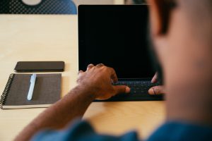 a man typing on his laptop